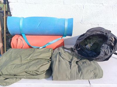 Military issued sleeping bag. - bed cushions - coveralls - and a waterproof military bag cover