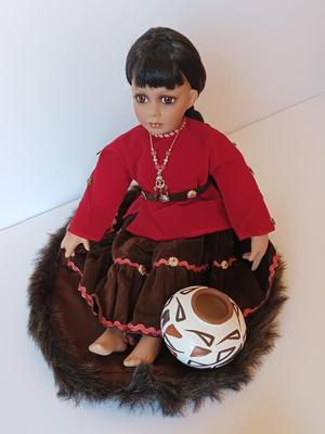 Porcelain Native American doll with small clay pot