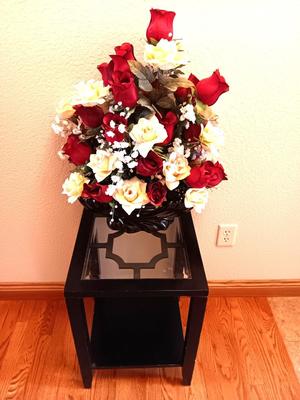 Black framed - glass topped end table with a beautiful bouquet of faux Roses.