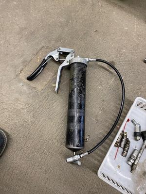 Air actuated and pistol grip grease gun with spare parts
