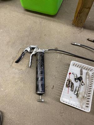Air actuated and pistol grip grease gun with spare parts