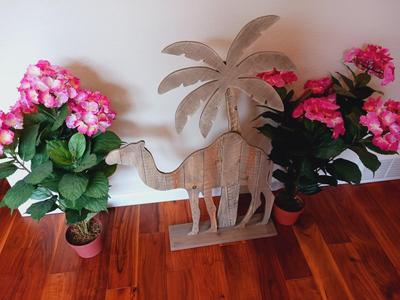 FREE STANDING WOODEN CAMEL AND 2 FAUX FLOWERING PLANTS