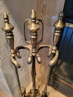 FIREPLACE TOOLS IN A HOLDER AND A CAST IRON WOOD STOVE REPLICA