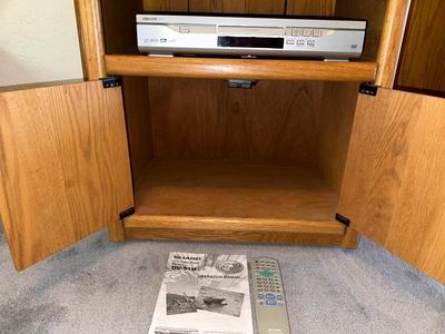 WOODEN CABINET ON CASTERS AND A SHARP DVD PLAYER W/REMOTE