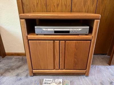 WOODEN CABINET ON CASTERS AND A SHARP DVD PLAYER W/REMOTE