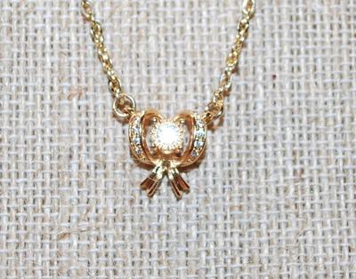 Clear Stones Array Gold Bowtie PENDANT (½" x ½") on a Gold Tone Necklace Chain 16" L