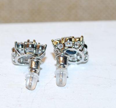 Oval Blue Center Stone Earrings Set with a Diamond-Style Shaped Cluster Surround on a Post Back