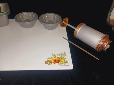 GLASS CUTTING BOARD, COOKIE PRESS, SMALL MOLDS AND LOAF PANS