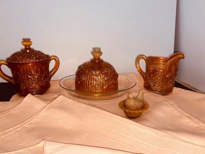 Beautiful Carnival Glass items and Miniature Nesting Hen Covered Dish with Peach Table Cloth
