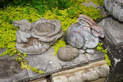 GROUPING OF THREE GARDEN RABBITS. TWO CEMENT AND ONE TERRA COTTA.