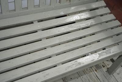 WOODEN GARDEN BENCH PAINTED A SOFT GREEN/ GREY TONE.