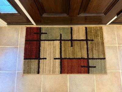 FLOOR VASE W/DRIED FOLIAGE AND AN ACCENT RUG