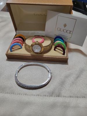 SWAVORSKI BRACELET AND A GUCCI WATCH