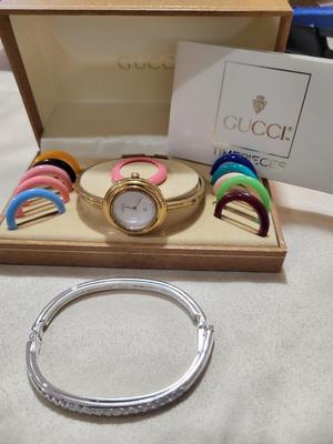 SWAVORSKI BRACELET AND A GUCCI WATCH