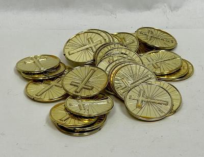 pile of plastic gold coins with crosses on both sides