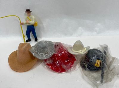 Miniature Cowboy Hats, a Top Hat with Cane, and a small plastic Fisherman Cake Topper figurine