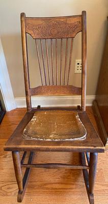 Antique wooden rocking chair with leather seat