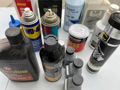 Assorted steering fluid, glass cleaner, chain oil, etc