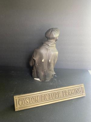 WORKING MAN WITH A STACK OF PAPERS AND BRONZE PLAQUE
