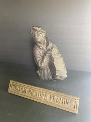 WORKING MAN WITH A STACK OF PAPERS AND BRONZE PLAQUE