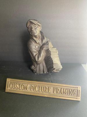 WORKING MAN WITH A STACK OF PAPERS AND BRONZE PLAQUE