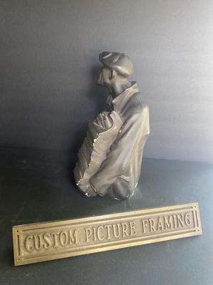 WORKING MAN WITH A STACK OF PAPERS AND BRONZE PLAQUE