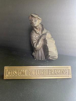 WORKING MAN WITH A STACK OF PAPERS AND BRONZE PLAQUE