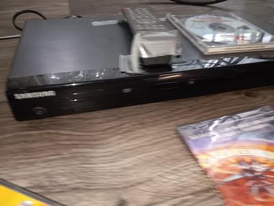 Samsung Dvd player and remote with a variety of dvd movies in different languages