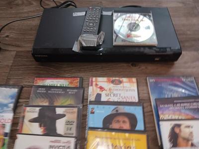 Samsung Dvd player and remote with a variety of dvd movies in different languages