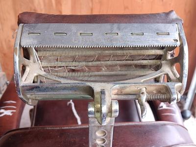 Antique barber chair with attached razor strap