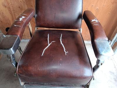 Antique barber chair with attached razor strap