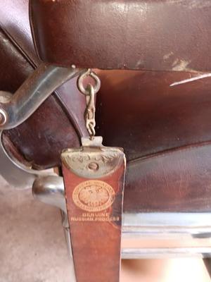 Antique barber chair with attached razor strap