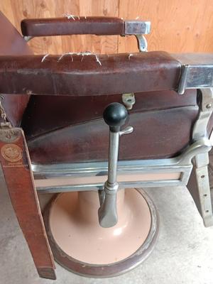 Antique barber chair with attached razor strap