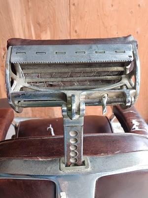 Antique barber chair with attached razor strap