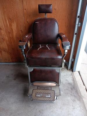 Antique barber chair with attached razor strap