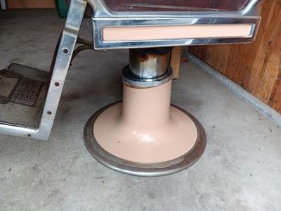 Antique barber chair with attached razor strap