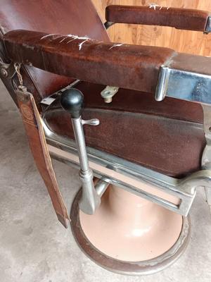 Antique barber chair with attached razor strap