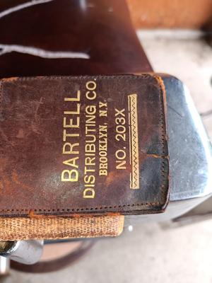 Antique barber chair with attached razor strap