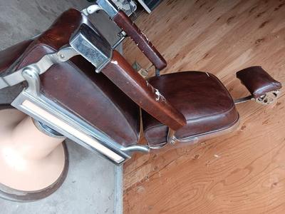 Antique barber chair with attached razor strap