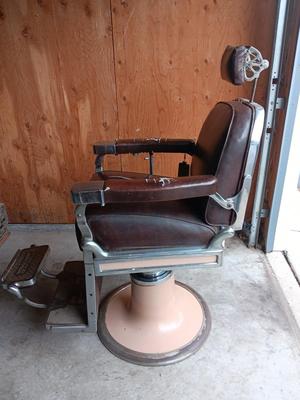 Antique barber chair with attached razor strap