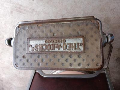 Antique barber chair with attached razor strap