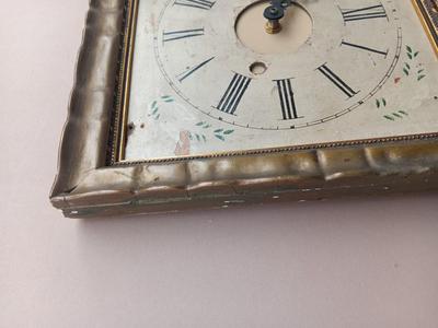 Wooden face clock framed in an art deco gold frame