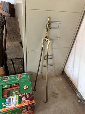 A CASE OF FIRE LOGS AND BRASS LOG TONGS