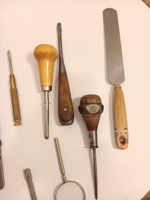 Assortment of older hand tools most with wooden handles