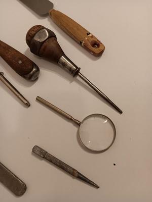 Assortment of older hand tools most with wooden handles