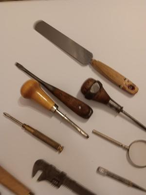 Assortment of older hand tools most with wooden handles