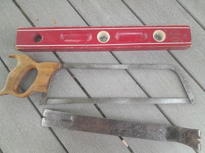Antique wooden Peerless level with hand saw claw bar and leather gloves