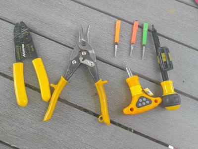 Assortment of yellow handled tools - wire strippers - tin snips= and drivers with bits