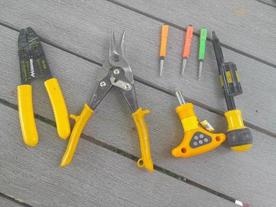 Assortment of yellow handled tools - wire strippers - tin snips= and drivers with bits