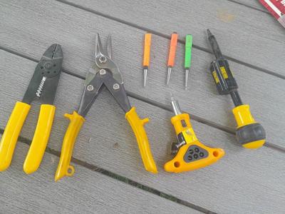 Assortment of yellow handled tools - wire strippers - tin snips= and drivers with bits